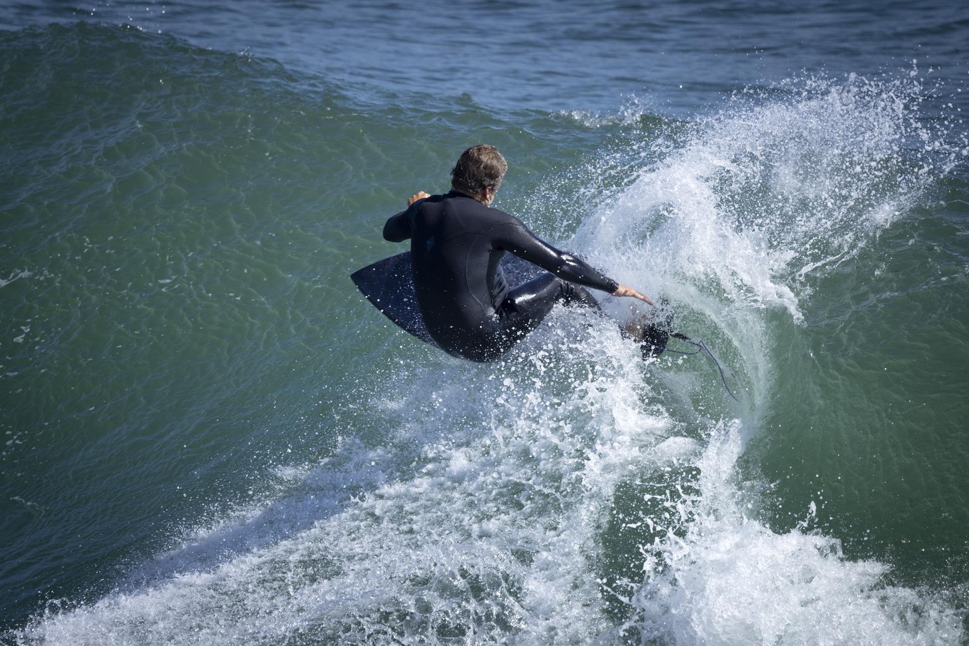 Surfer catches a wave